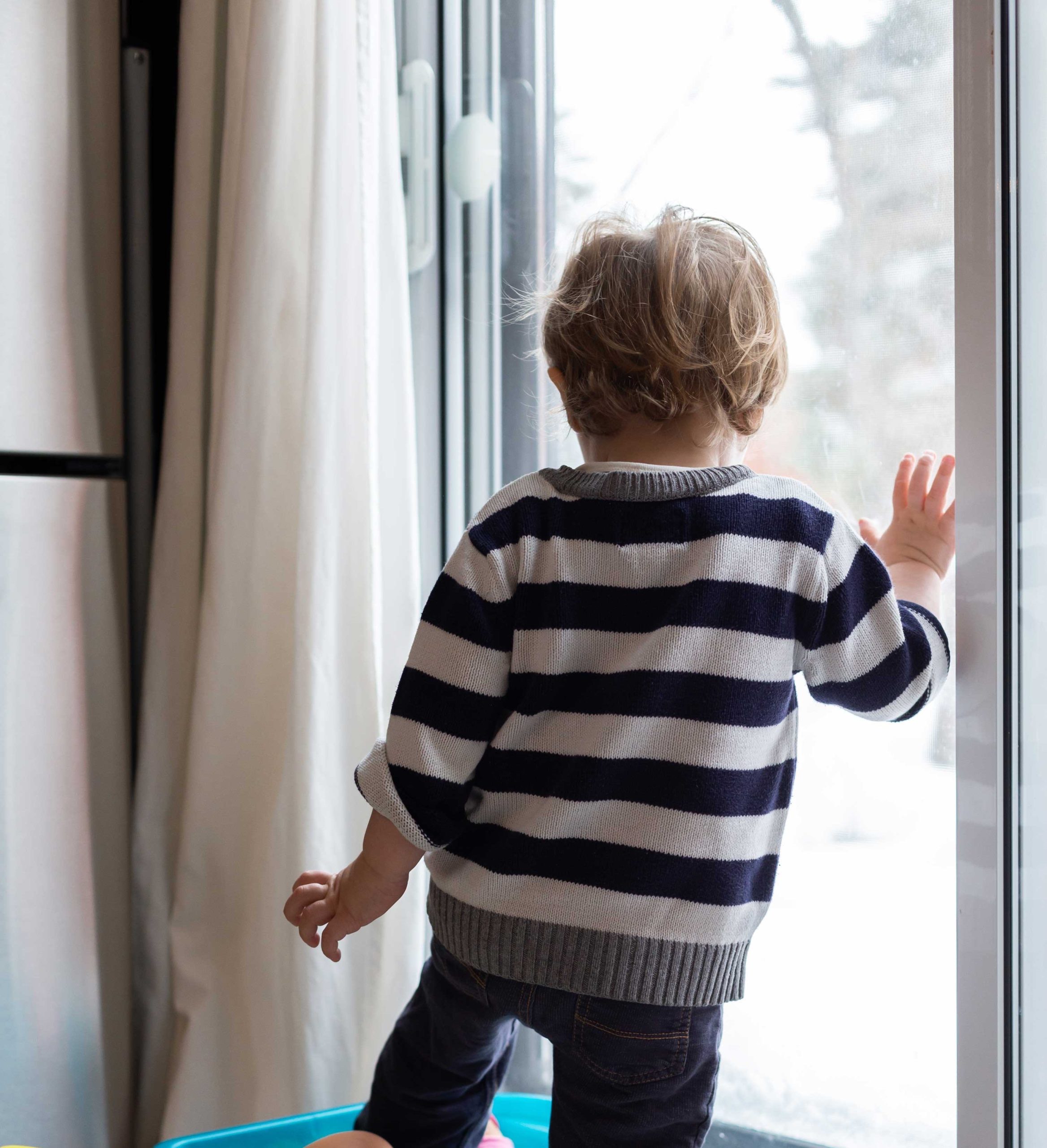 child with patio door