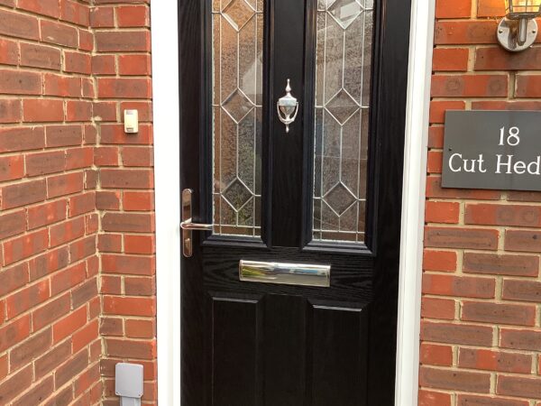 Black door featuring intricate detailing