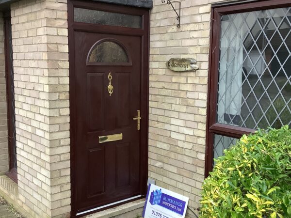 Oak door featuring gold hardware
