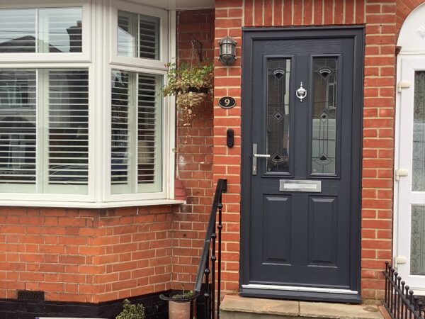 black front door with red brick