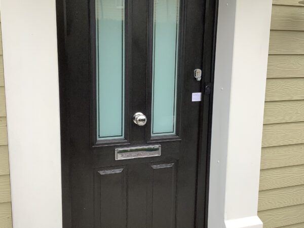 Black composite door with decorative