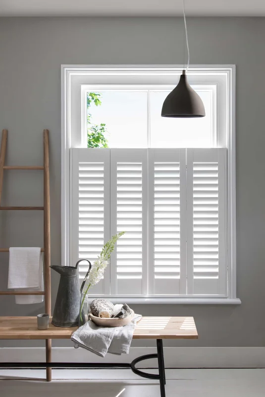 Bluemanor Windows café-style plantation shutters fitted to the lower half of a home office window.