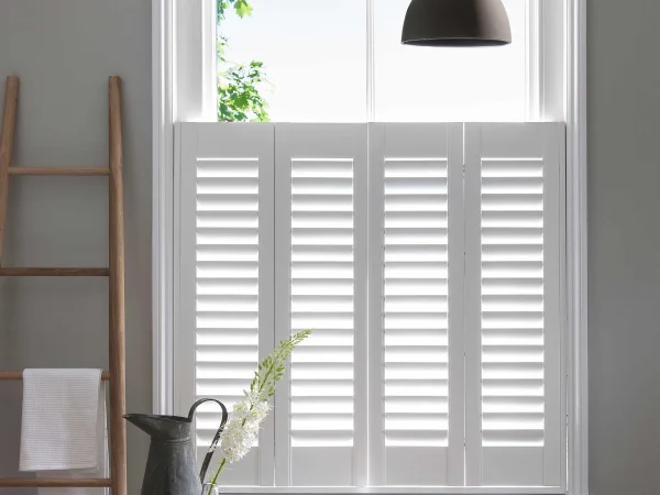 Bluemanor Windows café-style plantation shutters fitted to the lower half of a home office window.