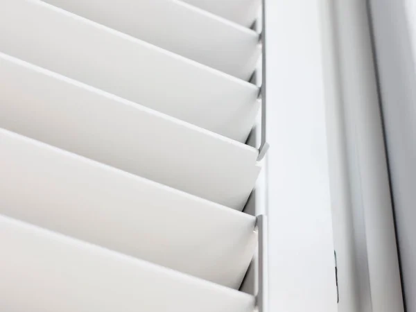 Close-up of Bluemanor Windows plantation shutter louvres with no visible front tilt rod.