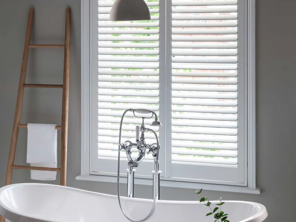 Bluemanor Windows full-height plantation shutters fitted above a freestanding bath.