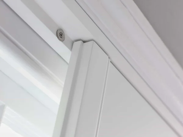 Close-up of the top corner and panel edge on Bluemanor Windows plantation shutters.