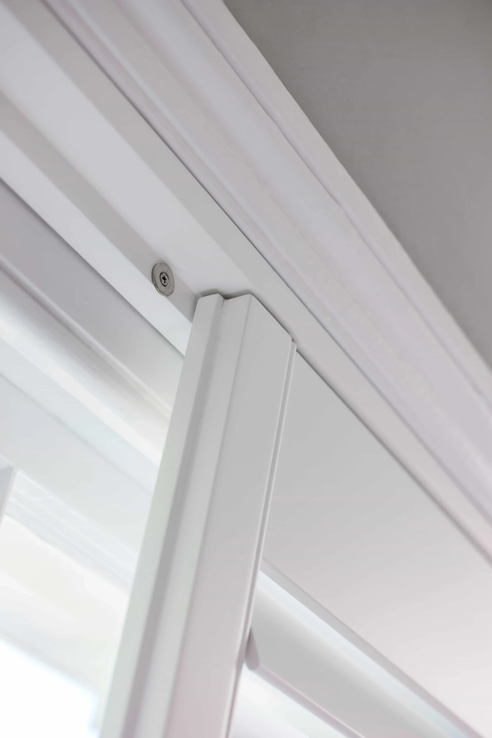 Close-up of the top corner and panel edge on Bluemanor Windows plantation shutters.